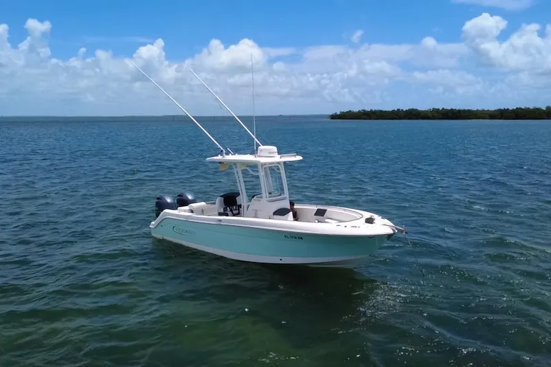 Slide: The Image of 2019 Robalo R242 Center Console boat on calm blue water under a clear sky. - 27
