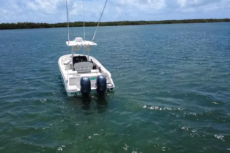 Slide: The Image of 2019 Robalo R242 Center Console boat on open water under blue sky. - 3