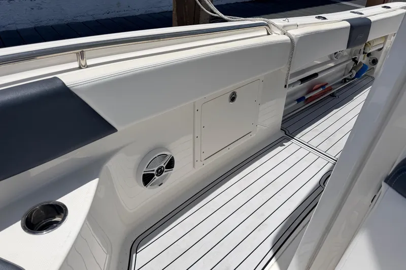 Slide: The Image of 2019 Robalo R242 Center Console boat interior with sleek white deck and storage compartments. - 31