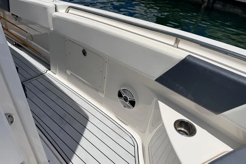 Slide: The Image of 2019 Robalo R242 Center Console boat interior with sleek seating and speaker. - 32