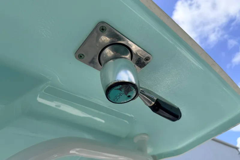Slide: The Image of Close-up of a 2019 Robalo R242 Center Console boat component against a blue sky. - 34