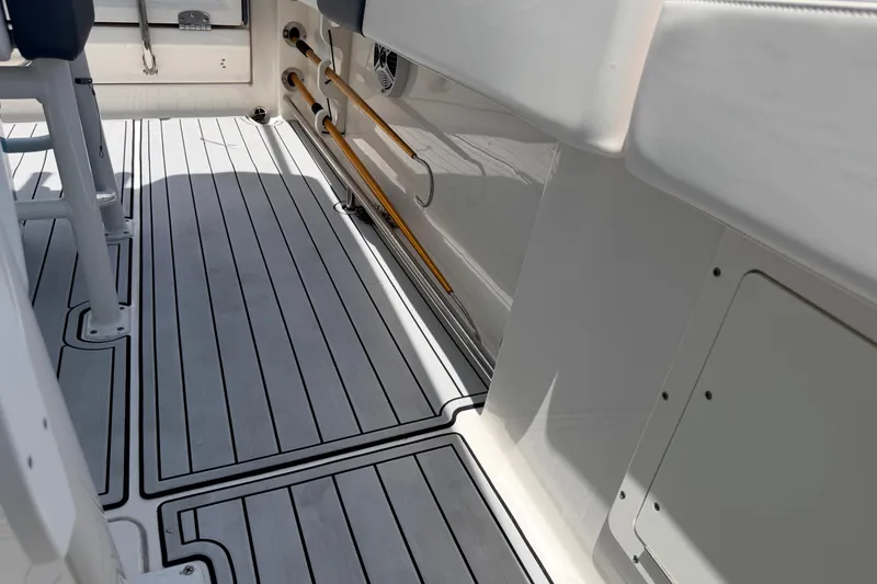 Slide: The Image of 2019 Robalo R242 Center Console boat interior with sleek, modern flooring design. - 35