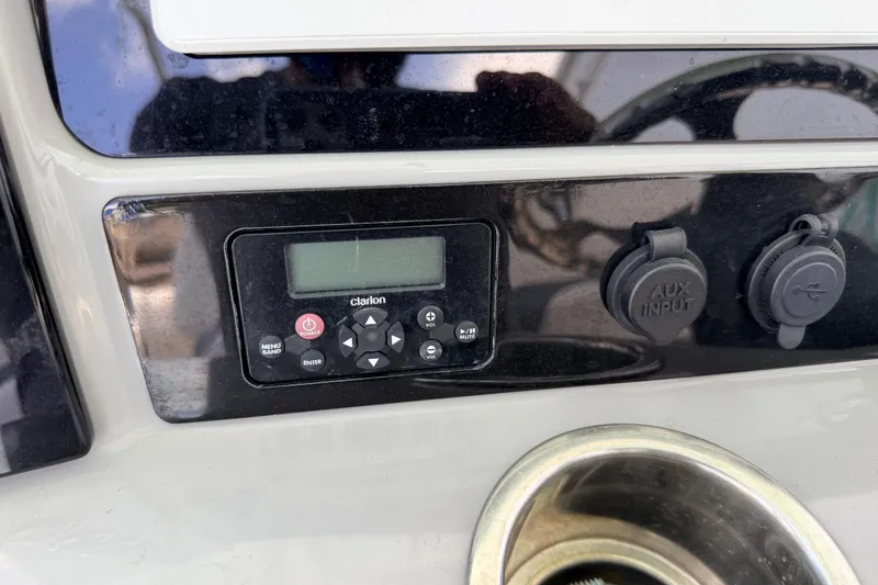 Slide: The Image of 2019 Robalo R242 Center Console dashboard with Clarion audio system and AUX input. - 40