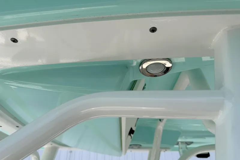 Slide: The Image of 2019 Robalo R242 Center Console boat detail, featuring sleek white and teal design elements. - 41