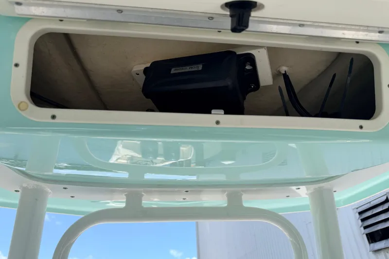 Slide: The Image of 2019 Robalo R242 Center Console storage compartment with wiring and equipment. - 42