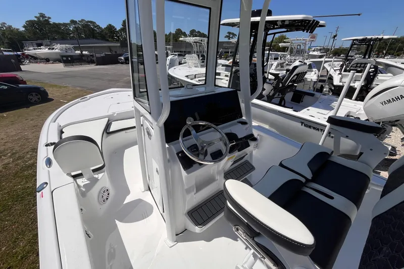 Slide: The Image of 2026 Tidewater 2210 Carolina Bay boat interior with steering console and seating. - 10