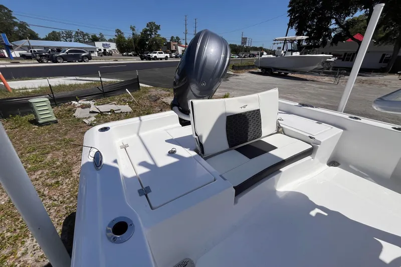 Slide: The Image of 2026 Tidewater 2210 Carolina Bay boat with sleek seating and powerful outboard motor. - 4