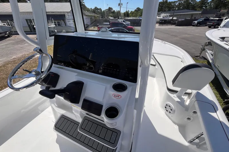 Slide: The Image of 2026 Tidewater 2210 Carolina Bay boat interior with steering wheel and control panel. - 6