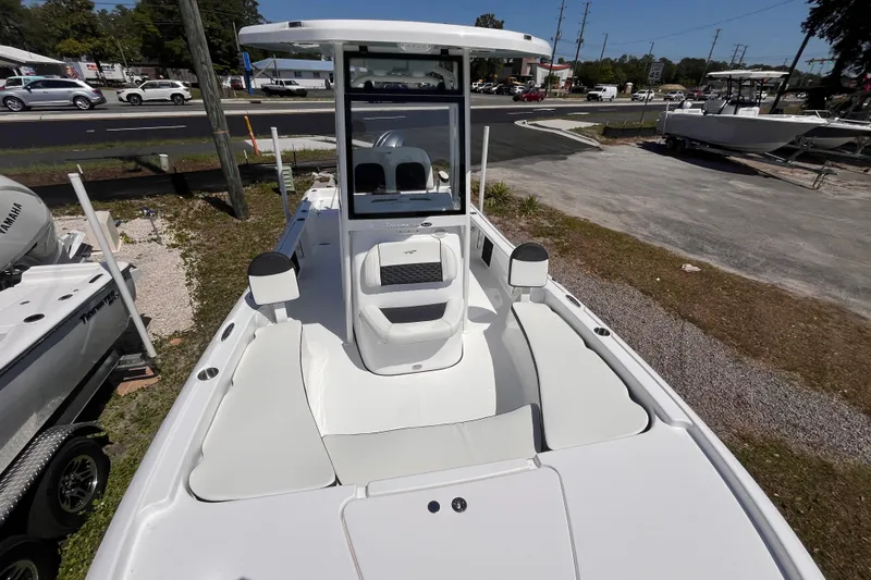 Slide: The Image of 2026 Tidewater 2210 Carolina Bay boat, white exterior, parked outdoors on gravel. - 8