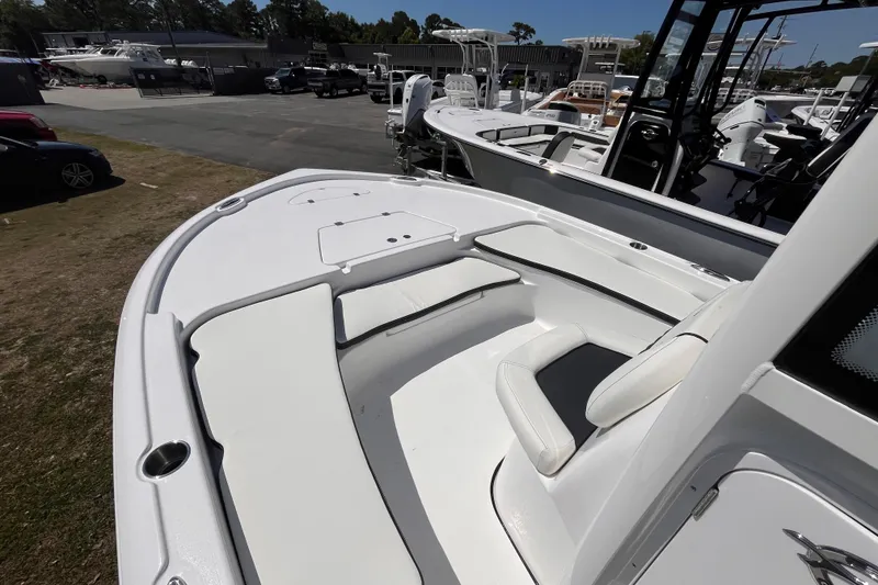Slide: The Image of 2026 Tidewater 2210 Carolina Bay boat with spacious seating and sleek design in a marina setting. - 9
