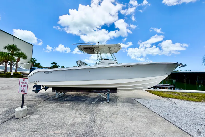 The Image of 2013 Edgewater 318CC boat on display under a clear blue sky. - 0