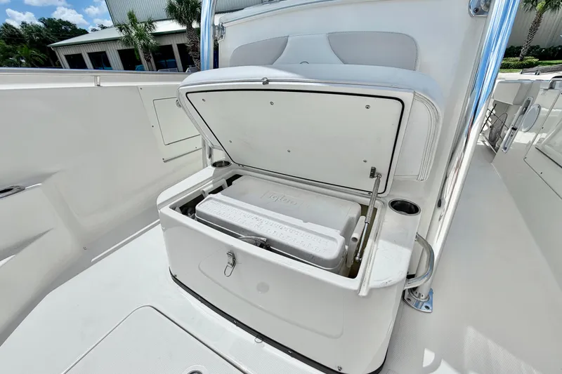 Slide: The Image of Open storage compartment on 2013 Edgewater 318CC boat with cooler inside. - 23