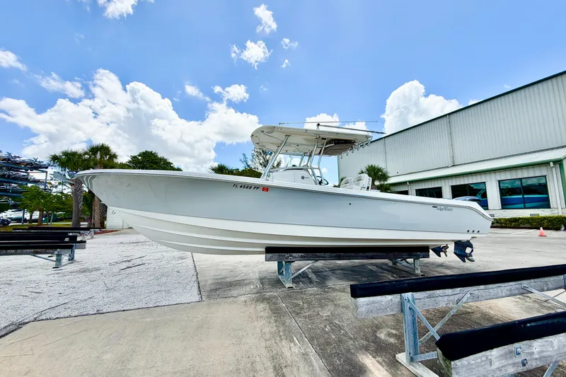 Slide: The Image of 2013 Edgewater 318CC boat on display outdoors, clear sky background. - 5