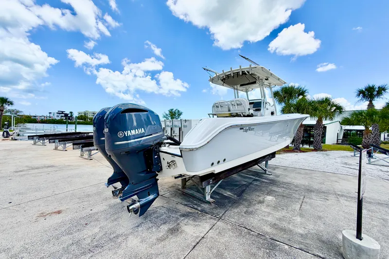 Slide: The Image of 2013 Edgewater 318CC boat with Yamaha engines on a sunny day at the marina. - 9