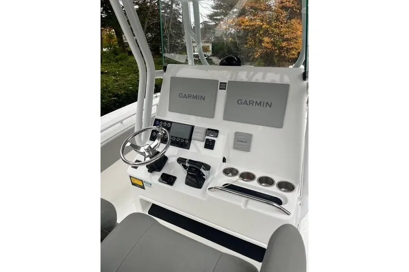 Slide: The Image of 2021 Cape Horn 32 XS boat console with Garmin navigation displays and controls. - 2
