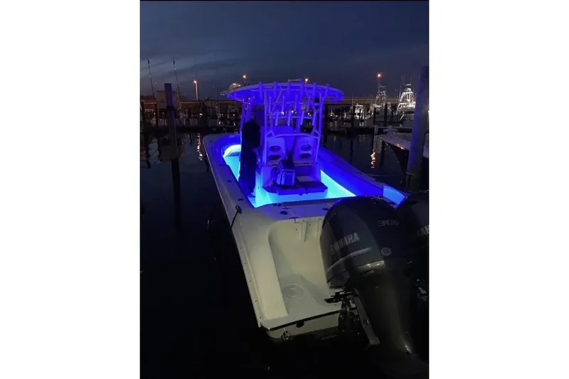 Slide: The Image of 2021 Cape Horn 32 XS boat with blue LED lights at night in marina. - 4