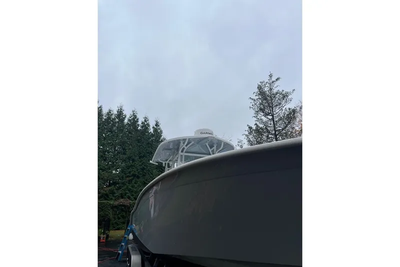 Slide: The Image of 2021 Cape Horn 32 XS boat with Garmin radar, surrounded by trees. - 6
