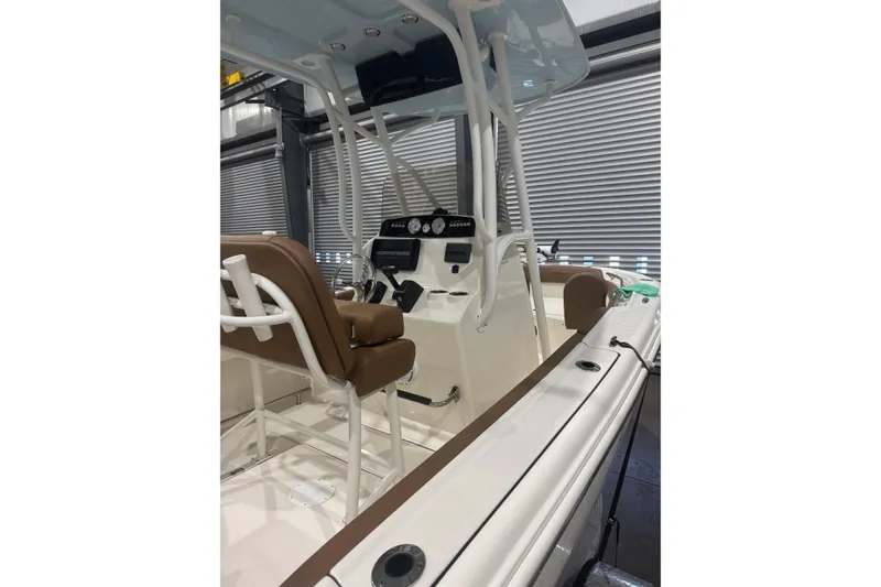 Slide: The Image of 2023 Pioneer 202 Islander boat interior with brown seating and modern dashboard. - 6