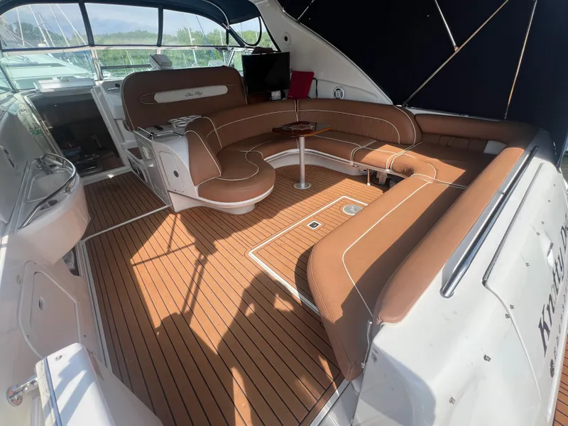 Slide: The Image of Interior of a 1997 Sea Ray 450 yacht with brown seating. - 1