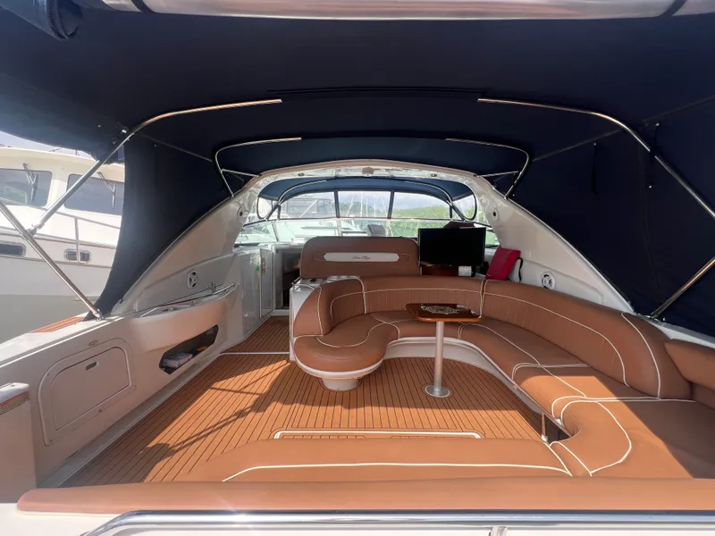 Slide: The Image of Interior of a 1997 Sea Ray 450 yacht with brown leather seating. - 10