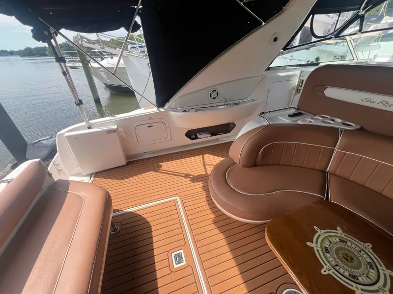 Slide: The Image of Interior of a 1997 Sea Ray 450 yacht with brown leather seating. - 13