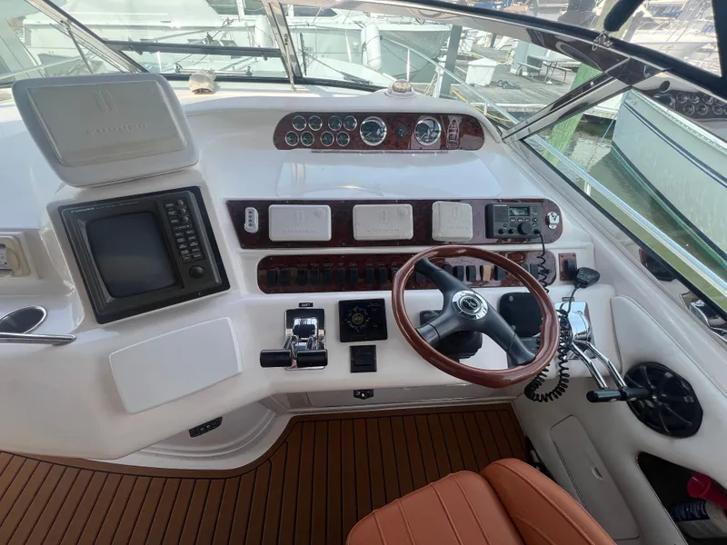 Slide: The Image of 1997 Sea Ray 450 yacht cockpit with steering wheel and instruments. - 19