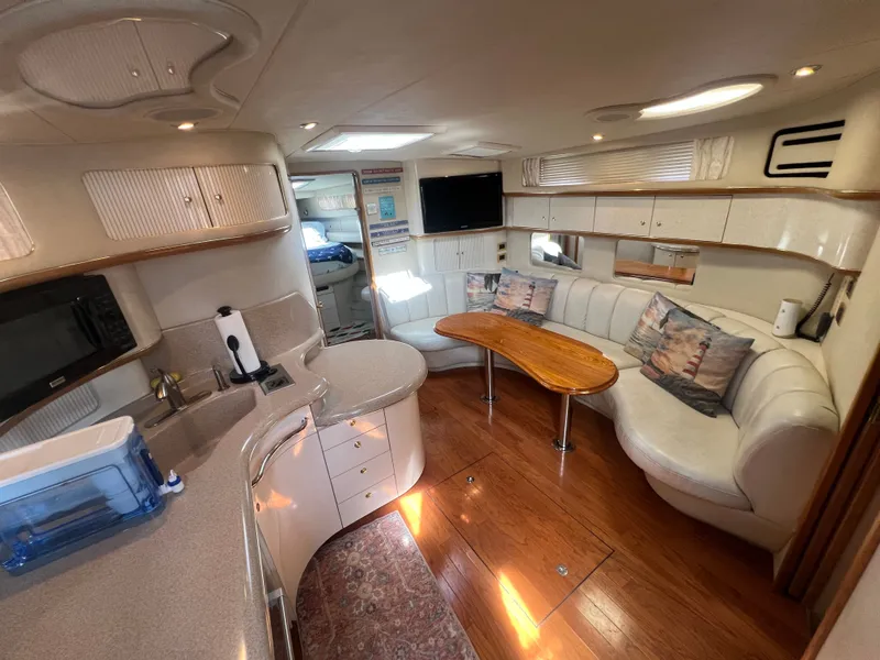 Slide: The Image of Interior of a 1997 Sea Ray 450 yacht with kitchen and lounge area. - 2