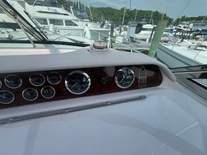 Slide: The Image of Dashboard of a 1997 Sea Ray 450 yacht in a marina. - 21