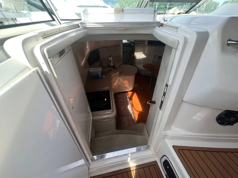 Slide: The Image of Interior of a 1997 Sea Ray 450 yacht with kitchen and seating area. - 24