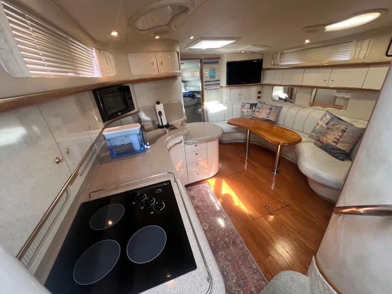 Slide: The Image of Interior of a 1997 Sea Ray 450 yacht with kitchen and seating area. - 25