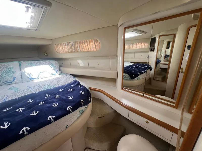Slide: The Image of Interior of a 1997 Sea Ray 450 yacht featuring a cozy bedroom. - 30