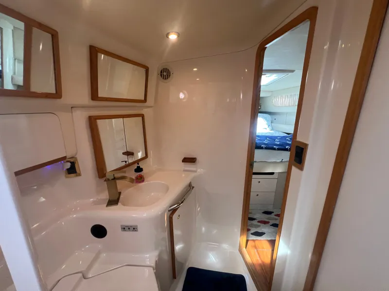Slide: The Image of Interior of a 1997 Sea Ray 450 yacht with bathroom and sleeping area. - 34