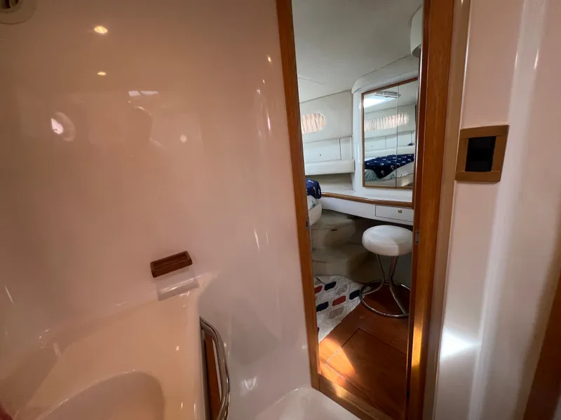 Slide: The Image of Interior of a 1997 Sea Ray 450 yacht, featuring cabin and mirror. - 35