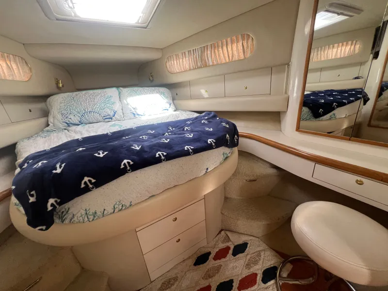 Slide: The Image of Interior of a 1997 Sea Ray 450 yacht featuring a cozy bedroom. - 36