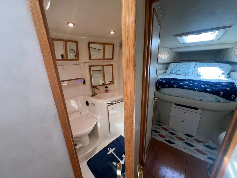 Slide: The Image of Interior of a 1997 Sea Ray 450 yacht with bathroom and sleeping area. - 39