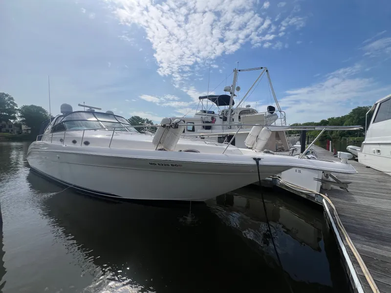 Slide: The Image of 1997 Sea Ray 450 yacht docked on a sunny day. - 4