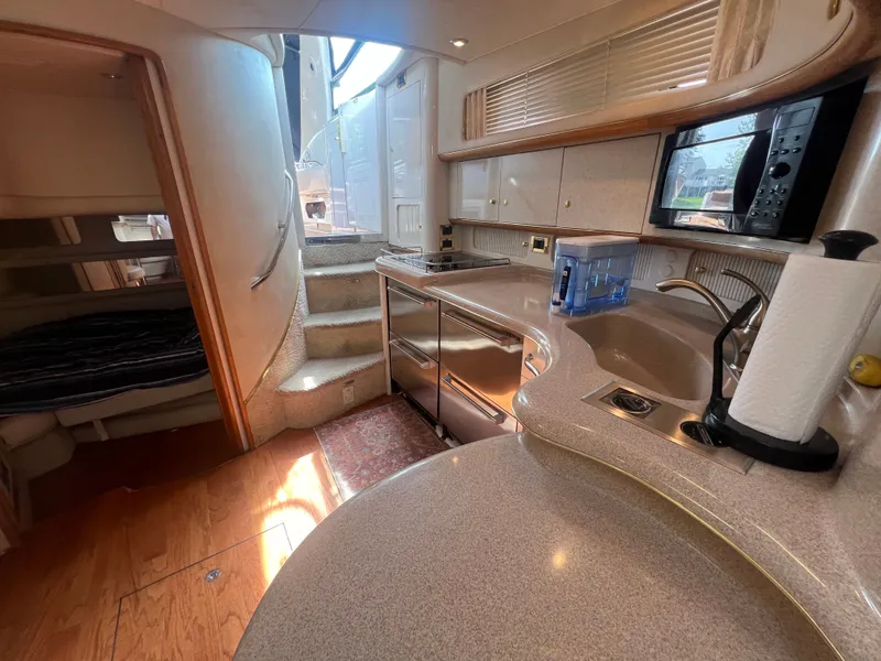 Slide: The Image of Interior of a 1997 Sea Ray 450 yacht with kitchen and sleeping area. - 40