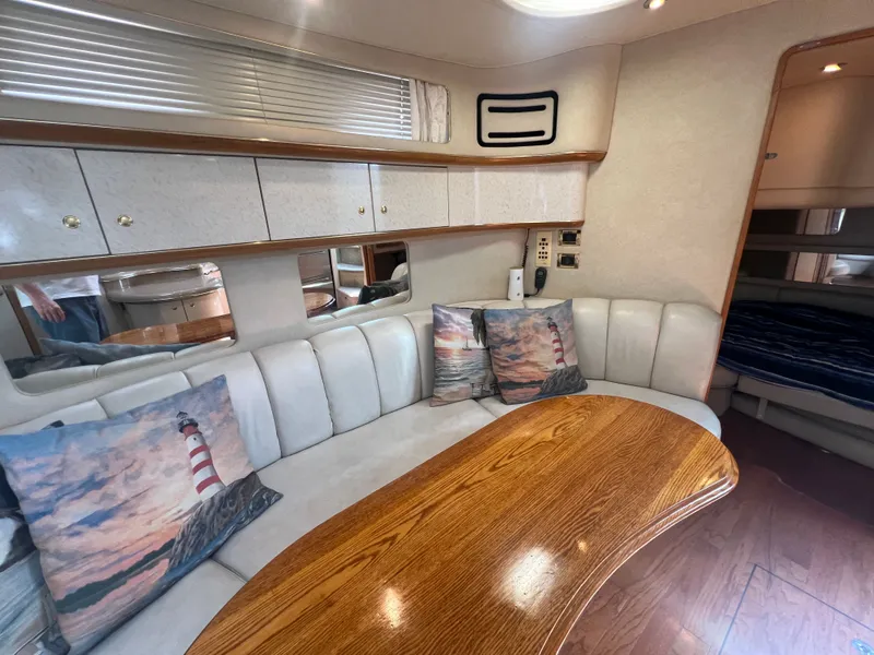 Slide: The Image of Interior of a 1997 Sea Ray 450 yacht with cozy seating area. - 41