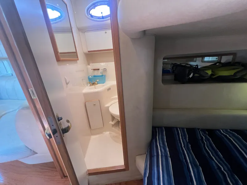 Slide: The Image of Interior of a 1997 Sea Ray 450 yacht with bathroom and sleeping area. - 46