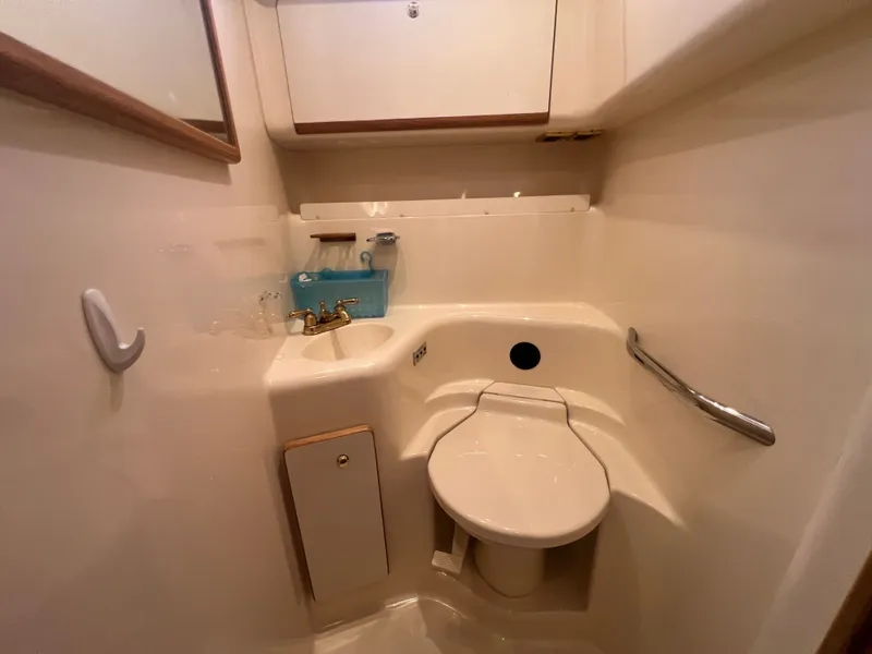 Slide: The Image of Interior of a 1997 Sea Ray 450 yacht bathroom with toilet and sink. - 48