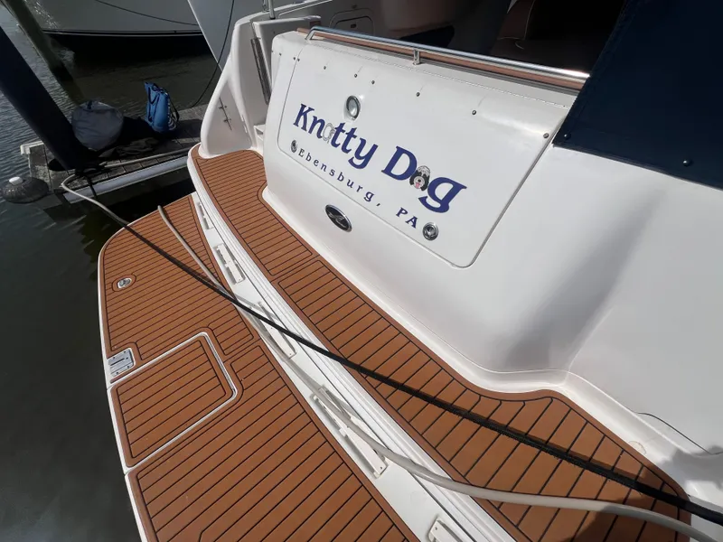 Slide: The Image of Rear view of a 1997 Sea Ray 450 yacht docked at harbor. - 7