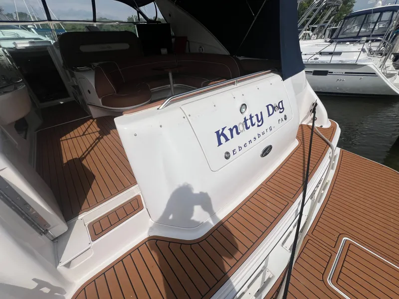 Slide: The Image of 1997 Sea Ray 450 yacht with wooden deck and "Knotty Dog" lettering. - 8