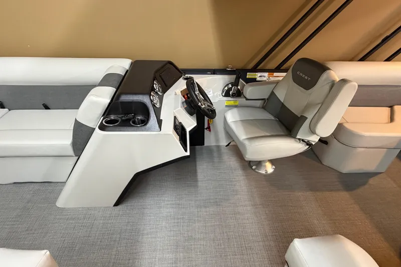 Slide: The Image of 2026 Crest Conquest SE 220 Cruise interior with helm, seating, and modern dashboard. - 4