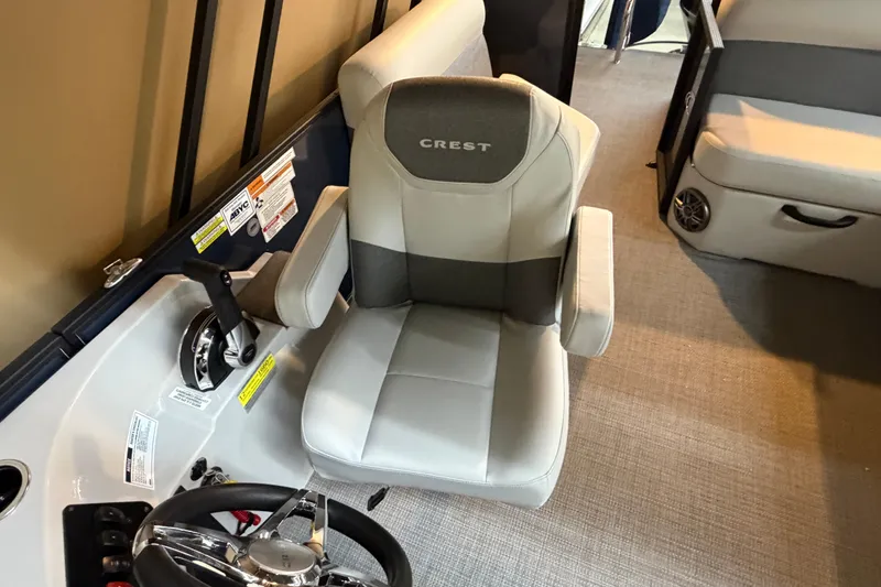Slide: The Image of Captain's chair in 2026 Crest Conquest SE 220 Cruise boat interior. - 5