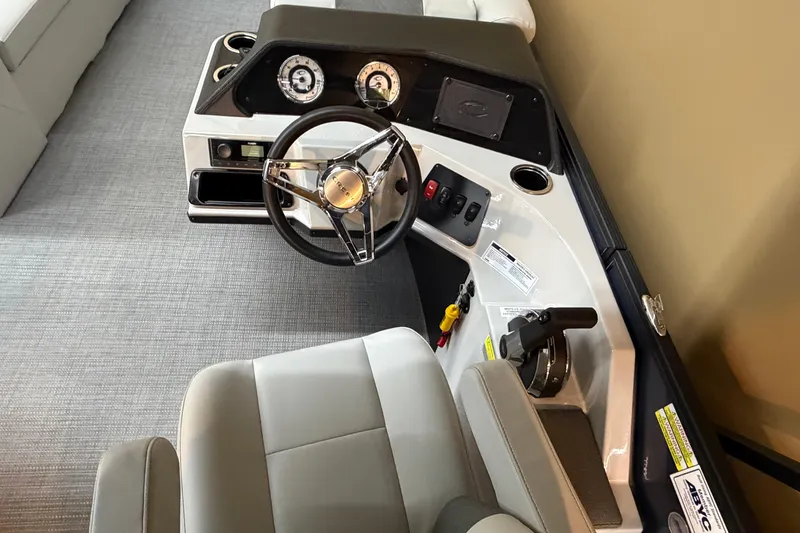Slide: The Image of Captain's helm of 2026 Crest Conquest SE 220 Cruise boat with steering wheel and controls. - 6
