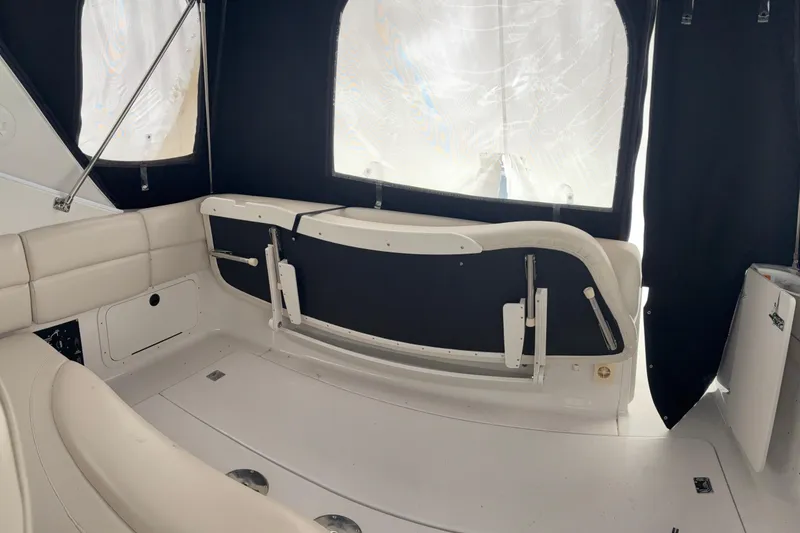 Slide: The Image of Interior of 1999 Four Winns 328 Vista boat with beige seating and black curtains. - 12