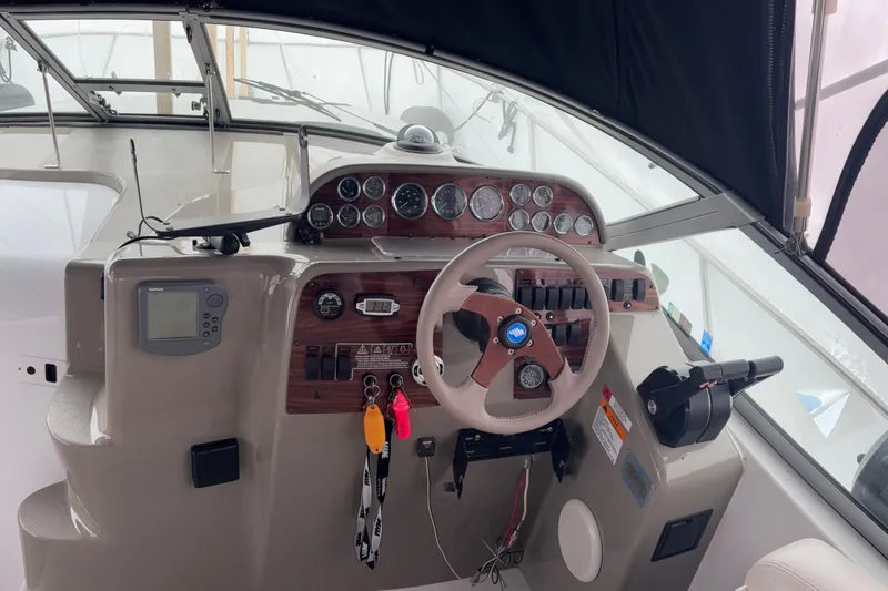 Slide: The Image of Cockpit of 1999 Four Winns 328 Vista boat with steering wheel and instrument panel. - 13