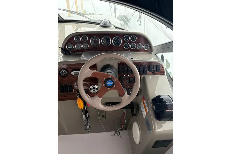 Slide: The Image of 1999 Four Winns 328 Vista boat dashboard with steering wheel and instrument panel. - 14
