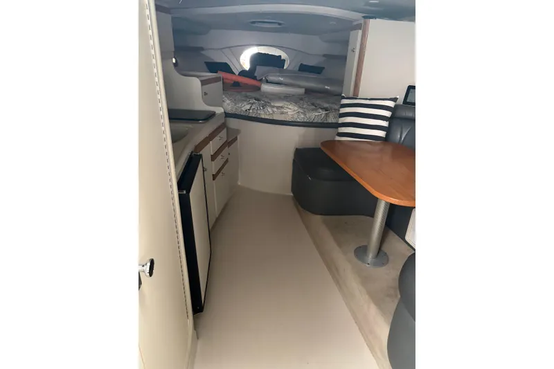 Slide: The Image of Interior of 1999 Four Winns 328 Vista boat with kitchenette and seating area. - 16