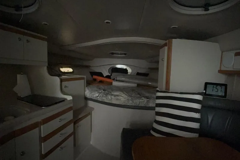 Slide: The Image of Interior of 1999 Four Winns 328 Vista boat with cozy cabin and striped pillow. - 20
